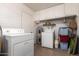 Laundry room with washer, dryer, and plenty of storage space at 6337 E Evergreen St, Mesa, AZ 85205