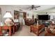 Cozy living room featuring plush seating, wooden furniture, and decorative shelving at 6337 E Evergreen St, Mesa, AZ 85205