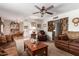 Spacious living room and dining area with ceiling fan, comfortable furniture, and dining set at 6337 E Evergreen St, Mesa, AZ 85205
