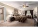 A spacious bedroom featuring a ceiling fan, carpet flooring, and natural light at 6337 E Evergreen St, Mesa, AZ 85205