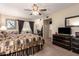 A spacious bedroom featuring a ceiling fan, carpet flooring, and natural light at 6337 E Evergreen St, Mesa, AZ 85205