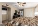 A spacious bedroom featuring a ceiling fan, carpet flooring, and natural light at 6337 E Evergreen St, Mesa, AZ 85205