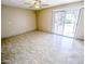 Large bedroom with tile floors, neutral walls, and sliding glass door leading to a patio at 6721 E Phelps Rd, Scottsdale, AZ 85254