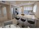 Bright kitchen featuring white cabinetry, stainless steel appliances, and granite countertops with bar seating at 6721 E Phelps Rd, Scottsdale, AZ 85254