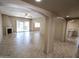 Spacious open-concept living room with tile flooring, fireplace, and seamless transition to kitchen at 6721 E Phelps Rd, Scottsdale, AZ 85254