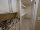 Pantry featuring built in cabinets with granite countertop and shelving at 6721 E Phelps Rd, Scottsdale, AZ 85254