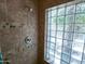 Tiled shower with glass block window providing natural light and added privacy at 6721 E Phelps Rd, Scottsdale, AZ 85254