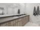 Modern bathroom featuring a double sink vanity, stylish mirrors, and marble accents at 7180 E Kierland Blvd # 316, Scottsdale, AZ 85254