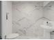 Contemporary bathroom featuring a toilet and sink with stylish marble-patterned tile at 7180 E Kierland Blvd # 316, Scottsdale, AZ 85254