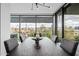 Modern dining room table centered in front of floor to ceiling windows, offering a captivating view of the surrounding neighborhood at 7180 E Kierland Blvd # 316, Scottsdale, AZ 85254