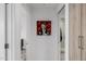 Hallway view displaying modern art and access to a bathroom with an open doorway at 7180 E Kierland Blvd # 316, Scottsdale, AZ 85254