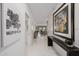 Hallway view to the living room featuring unique art and pristine marble floors at 7180 E Kierland Blvd # 316, Scottsdale, AZ 85254