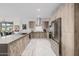 Well-lit kitchen featuring modern cabinets, stainless steel appliances, and a view into the dining area at 7180 E Kierland Blvd # 316, Scottsdale, AZ 85254