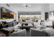 Spacious living room featuring TV and city views from large windows at 7180 E Kierland Blvd # 316, Scottsdale, AZ 85254