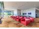 Bright lounge area featuring comfortable red seating, media screens, and contemporary design at 7180 E Kierland Blvd # 316, Scottsdale, AZ 85254