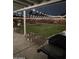 Backyard featuring an outdoor seating area with a grill, decorative lighting, and a well maintained lawn at 7235 W Flower St, Phoenix, AZ 85033