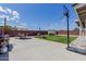 Spacious backyard with patio, grassy area, fire pit, and basketball court at 7235 W Flower St, Phoenix, AZ 85033