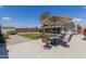Outdoor seating area in a large, well-maintained backyard with grass and storage shed at 7235 W Flower St, Phoenix, AZ 85033