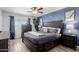 Main bedroom features neutral paint, ceiling fan, dresser and wood-look floors at 7235 W Flower St, Phoenix, AZ 85033