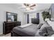 Bedroom features wood-look floors, natural light, dresser and ceiling fan at 7235 W Flower St, Phoenix, AZ 85033