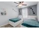 Bedroom with two beds, gray curtains, and a ceiling fan at 7235 W Flower St, Phoenix, AZ 85033