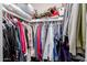 Walk-in closet features an assortment of clothes and shelves for organization at 7235 W Flower St, Phoenix, AZ 85033
