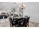 Open concept dining room features wood-look floors, view to kitchen, and neutral paint at 7235 W Flower St, Phoenix, AZ 85033