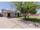 Single-story home with a covered carport and well-kept lawn, creating a welcoming curb appeal at 7235 W Flower St, Phoenix, AZ 85033
