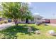 Charming single-story home featuring a well-maintained lawn and stone pathway leading to the front door at 7235 W Flower St, Phoenix, AZ 85033