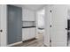Hallway featuring storage and hardwood floors with an open doorway at 7235 W Flower St, Phoenix, AZ 85033