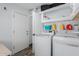 A spacious laundry room with a washer, dryer, and storage shelves at 7235 W Flower St, Phoenix, AZ 85033