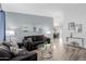 Bright living room with stylish decor, tile floors, and an open view into the dining area at 7235 W Flower St, Phoenix, AZ 85033