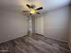 Bedroom with ceiling fan, closet, and wood floors, creating a cozy and inviting space at 8115 N 56Th Ave, Glendale, AZ 85302