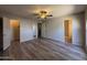 Spacious bedroom with hardwood floors and a ceiling fan, leading to walk-in closets at 8115 N 56Th Ave, Glendale, AZ 85302