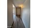 A hallway features sleek, modern floors and leads to a front door for easy access at 8115 N 56Th Ave, Glendale, AZ 85302