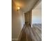 Inviting hallway with updated floors, neutral paint, and contemporary lighting fixtures at 8115 N 56Th Ave, Glendale, AZ 85302