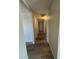 Hallway view with several closets for storage and hardwood flooring throughout the home at 8115 N 56Th Ave, Glendale, AZ 85302
