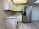Well-designed kitchen with stainless steel refrigerator, granite countertops and ample cabinet space at 8115 N 56Th Ave, Glendale, AZ 85302