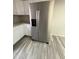 Spacious kitchen featuring a modern, stainless steel refrigerator and ample cabinet space at 8115 N 56Th Ave, Glendale, AZ 85302