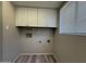 Well-lit laundry room featuring white cabinets and convenient hookups for laundry appliances at 8115 N 56Th Ave, Glendale, AZ 85302