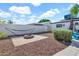 Cozy backyard featuring a fire pit, hammock, and a well-maintained privacy wall at 830 E Orchid Ln, Phoenix, AZ 85020