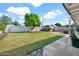 Large backyard with grass, a shed, and a block wall at 830 E Orchid Ln, Phoenix, AZ 85020