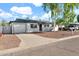 Quaint single-story house with a large driveway and mature landscaping, blending charm and functionality at 830 E Orchid Ln, Phoenix, AZ 85020