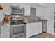 Modern kitchen with stainless steel appliances, sleek countertops, and ample storage for cooking and entertaining at 830 E Orchid Ln, Phoenix, AZ 85020