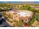 Attractive aerial view of a desert community with tile roofs, mature landscaping, and mountain views at 9270 E Thompson Peak Pkwy # 367, Scottsdale, AZ 85255