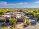 Stunning aerial view of a desert home with mature landscaping, a tile roof, and mountain views at 9270 E Thompson Peak Pkwy # 367, Scottsdale, AZ 85255