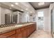 This bathroom features a double vanity with granite countertops and a glass-enclosed shower at 9270 E Thompson Peak Pkwy # 367, Scottsdale, AZ 85255