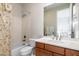 This bathroom boasts a tub and shower combo, toilet, vanity, and mirror at 9270 E Thompson Peak Pkwy # 367, Scottsdale, AZ 85255
