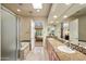 This bathroom boasts a soaking tub, dual vanities and granite countertops with open access to the bedroom at 9270 E Thompson Peak Pkwy # 367, Scottsdale, AZ 85255