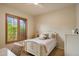 Cozy bedroom featuring a white frame bed, natural light from the large window, and neutral decor at 9270 E Thompson Peak Pkwy # 367, Scottsdale, AZ 85255